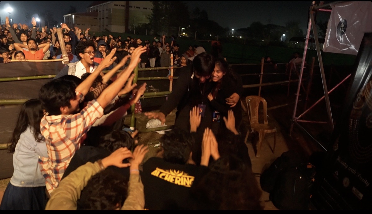 Priyal greeting the audience backstage at a university concert