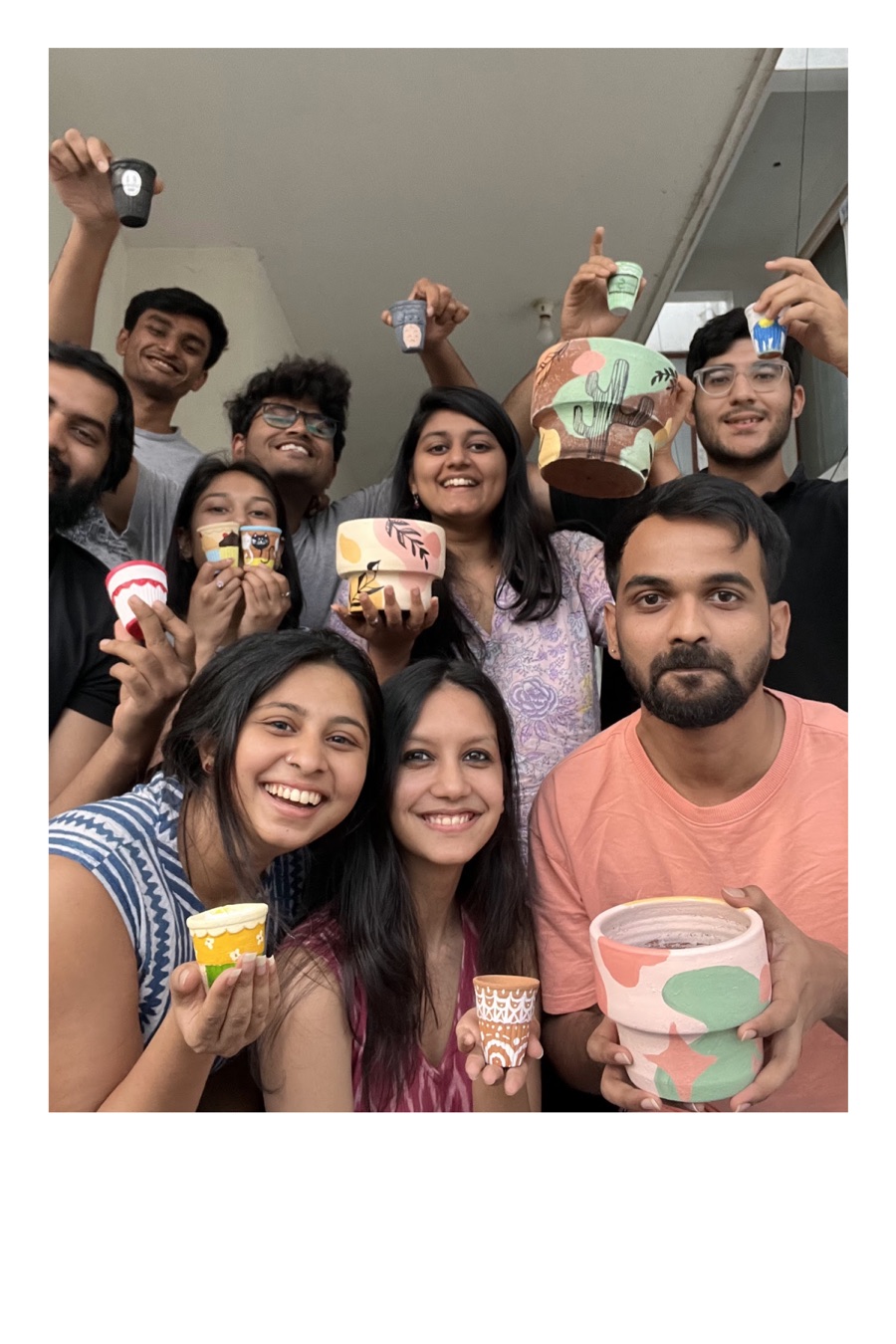 Priyal and friends holding hand-painted pottery