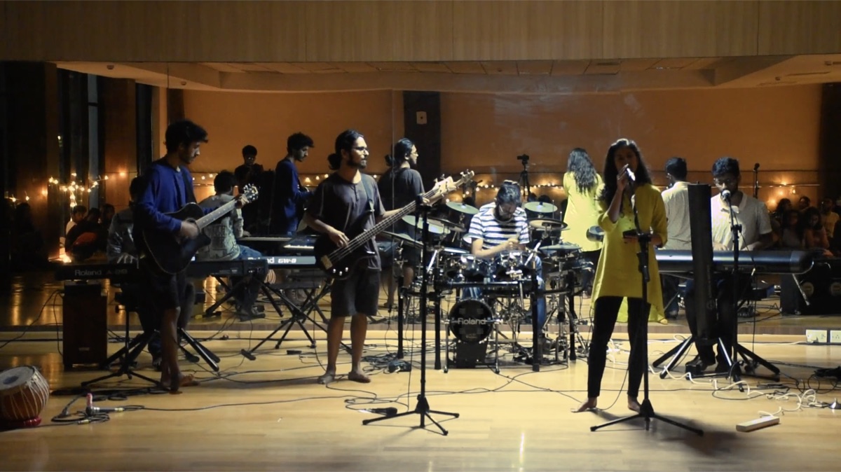 Priyal singing with a band on stage